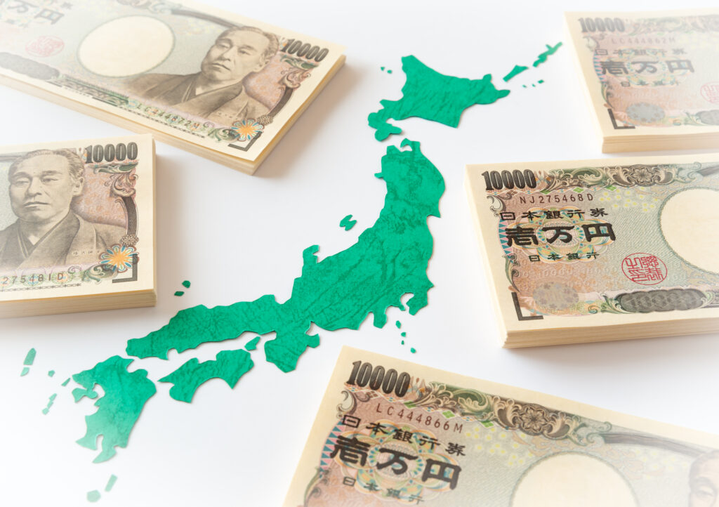 Stacks of Japanese yen banknotes surrounding a green map of Japan, emphasizing money and geography.