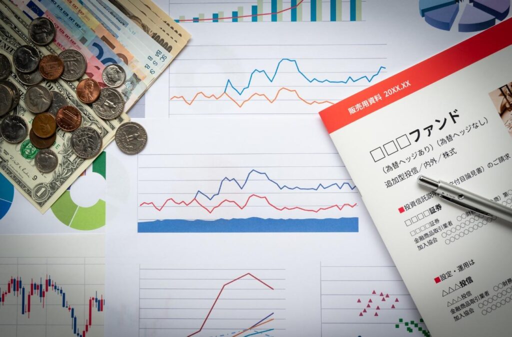 Financial charts and currency on a desk, suggesting market analysis and budgeting